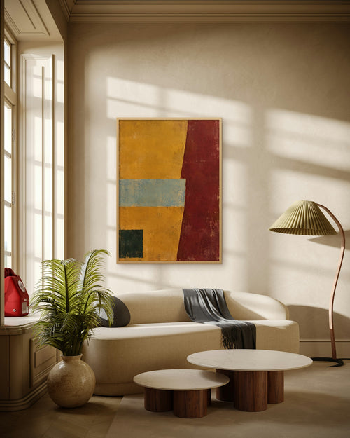 Amber Horizon art print in a natural oak frame above a cream sofa in a sunlit living room