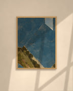 Blue Horizon art print in a natural oak frame above a cream sofa in a sunlit living room