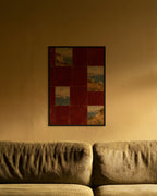 Burgundy Coast Tiles art print in a black frame above an olive corduroy sofa lit by a warm lamp