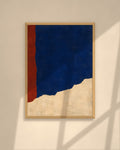 Cobalt Ridge art print in a walnut frame above a brown leather Chesterfield armchair
