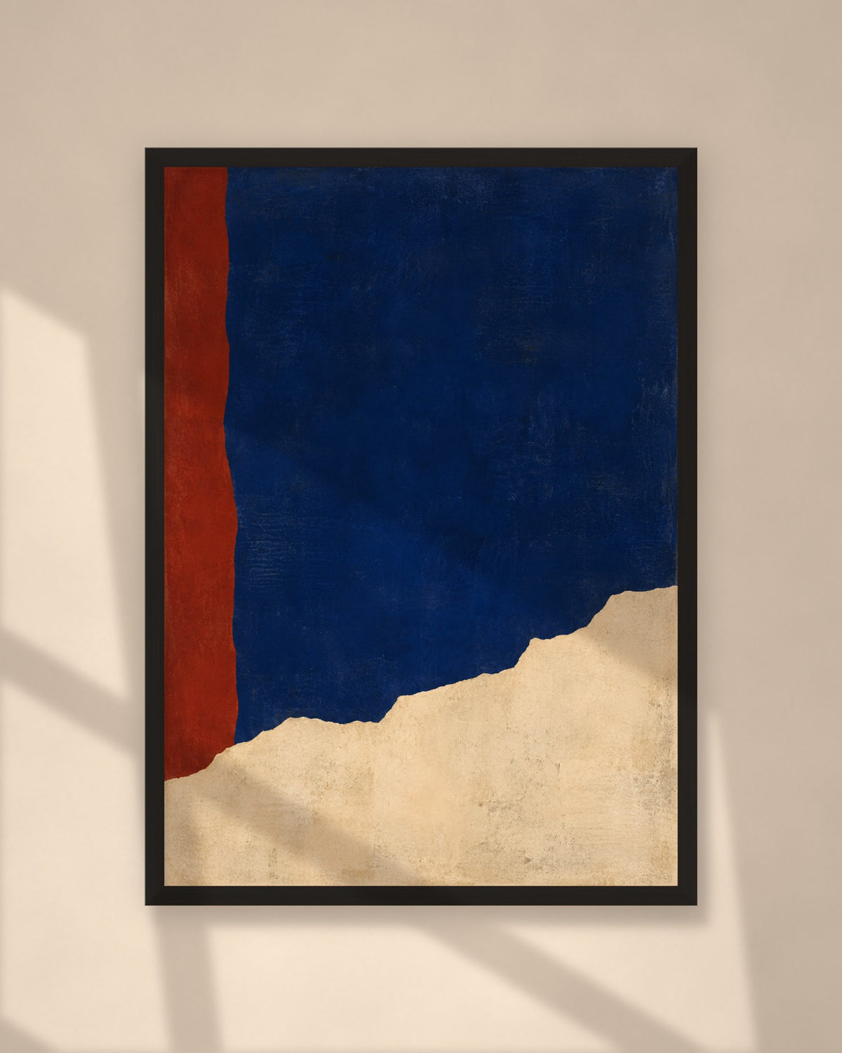 Cobalt Ridge art print in a black frame on a warm beige wall with sunlight and window shadows