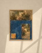 Garden in Blue art print in a natural oak frame above a cream sofa in a sunlit living room