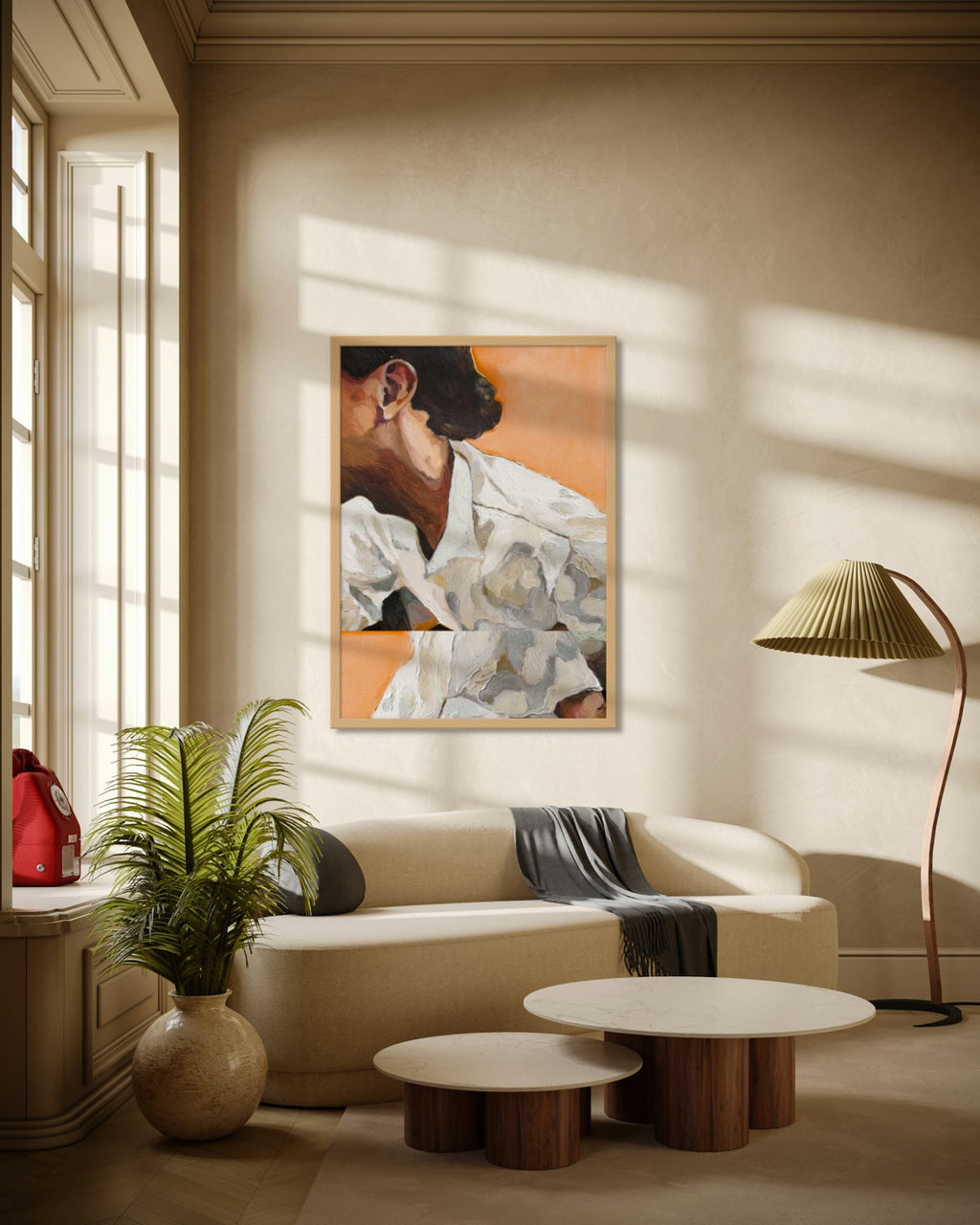 Linen in Apricot art print in a natural oak frame above a cream curved sofa in a sunlit living room