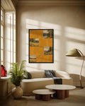 Ochre Lake Tiles art print in a black frame above a cream curved sofa in a sunlit living room