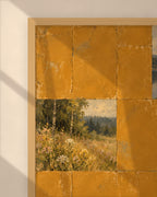 Ochre Lake Tiles art print in a natural oak frame above a cream sofa in a sunlit living room