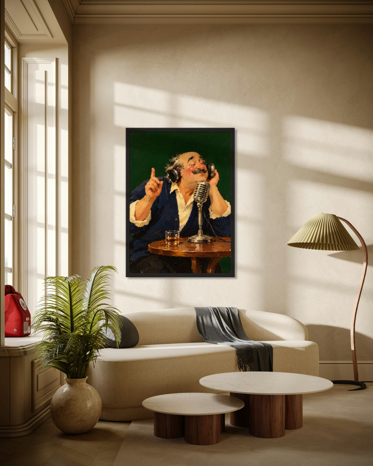 On Air art print in a black frame above a cream curved sofa in a sunlit living room