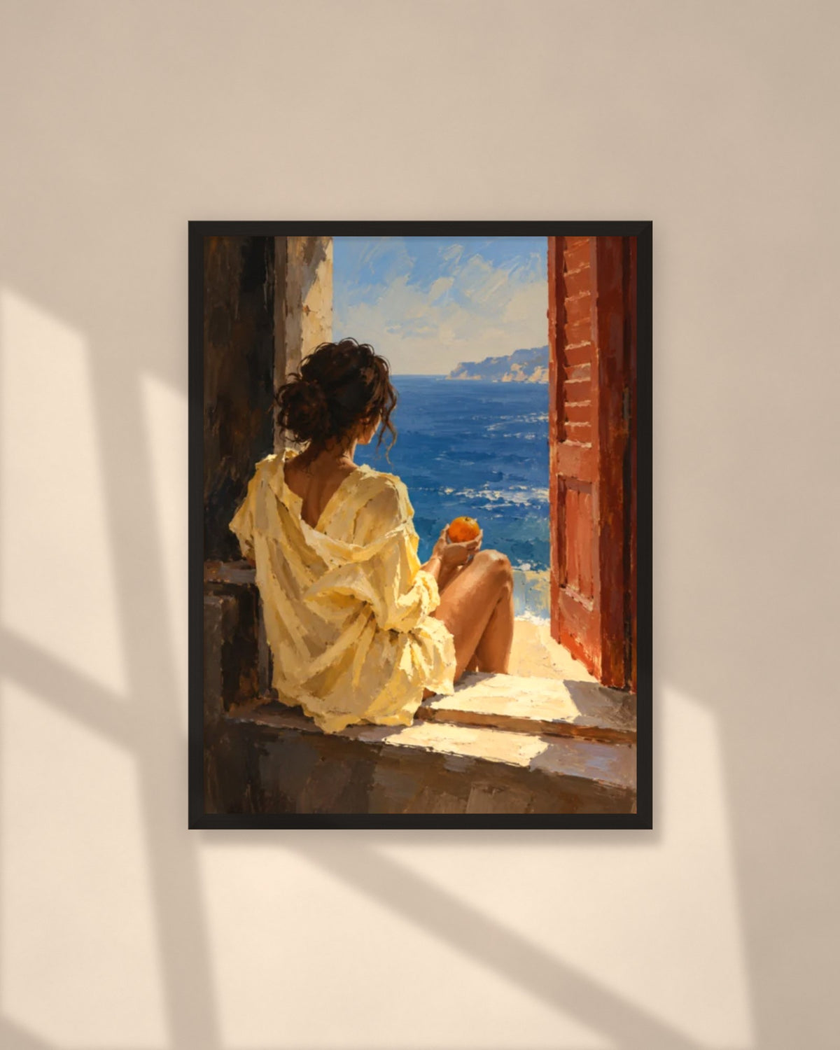 Orange by the Sea art print in a black frame on a warm beige wall with sunlight and window shadows