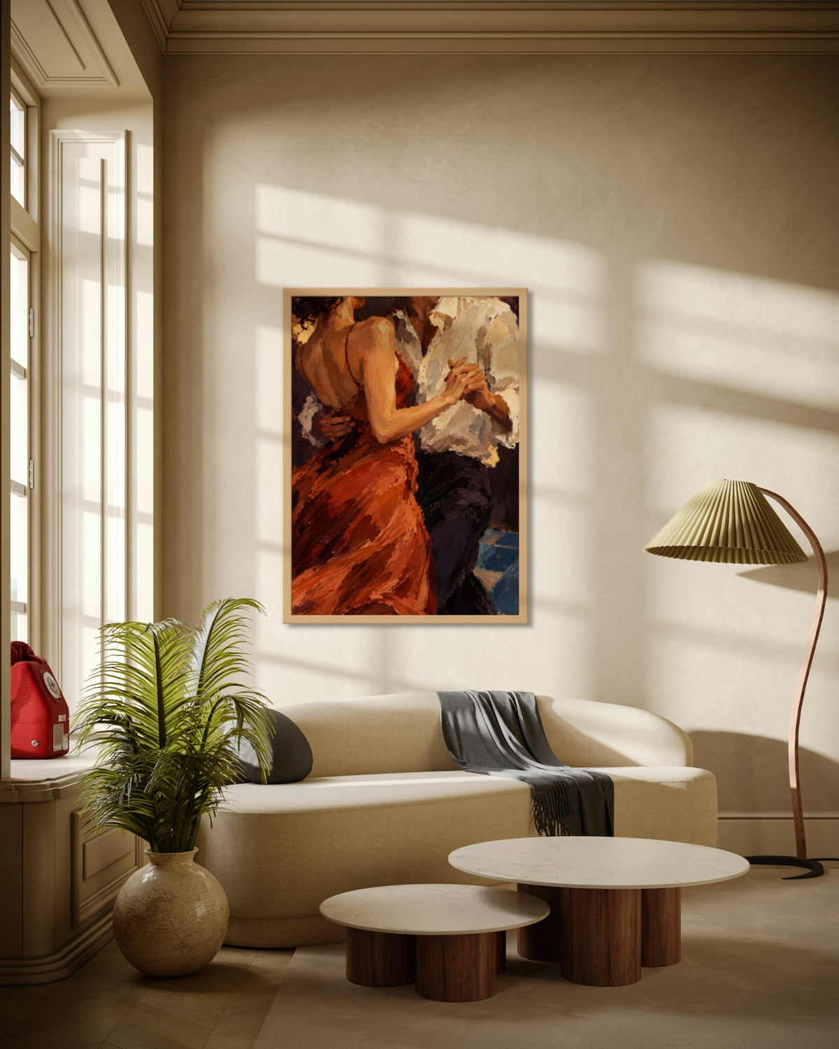 Slow Dance art print in a natural oak frame above a cream curved sofa in a sunlit living room