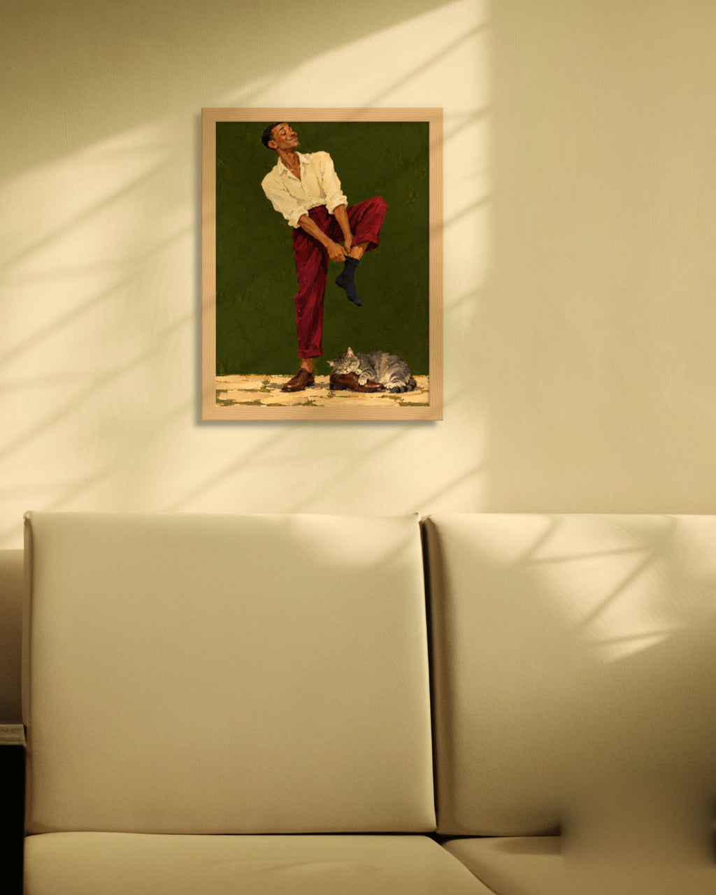 Sunday Socks art print in a natural oak frame on a cream wall with window shadows above a sofa