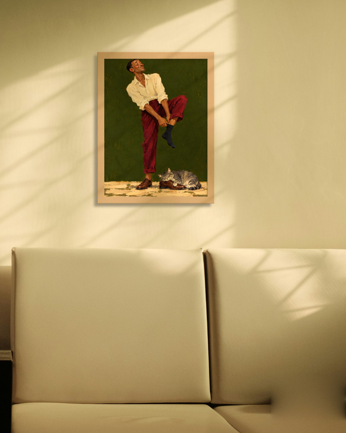 Sunday Socks art print in a natural oak frame on a cream wall with window shadows above a sofa