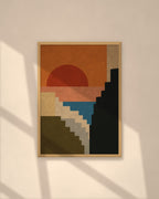 Sunset Cliffs art print in a natural oak frame on a warm plaster wall