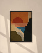 Sunset Cliffs art print in a black frame on a warm beige wall with sunlight and window shadows