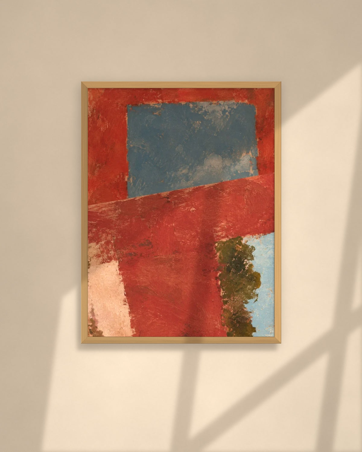 Terracotta Window art print in a natural oak frame above a cream sofa in a sunlit living room