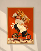 The Baguette Run art print in a natural oak frame on a warm plaster wall