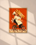 The Baguette Run art print in a natural oak frame above a wooden desk in a bright Scandinavian study