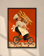 The Baguette Run art print in a black frame on a warm beige wall with sunlight and window shadows
