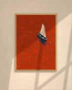 Vermilion Sail art print in a walnut frame above a brown leather Chesterfield armchair