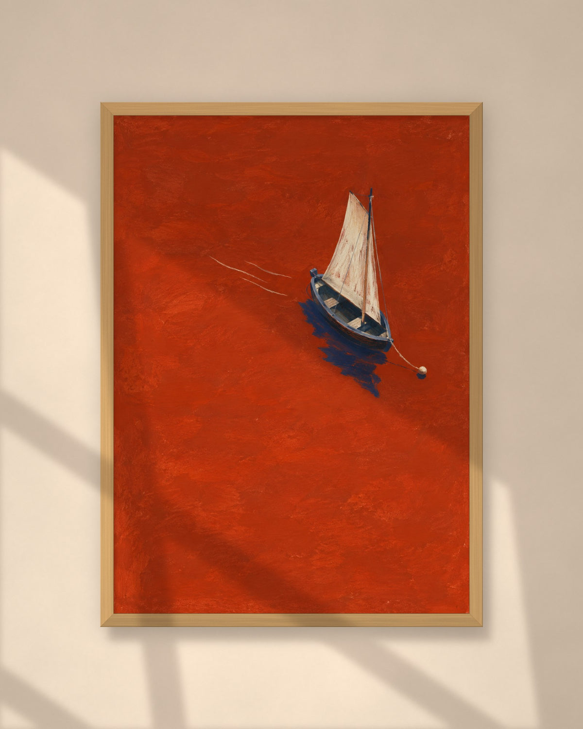 Vermilion Sail art print in a natural oak frame on a warm plaster wall
